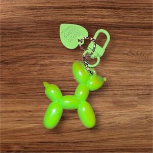 Bright green iridescent, balloon dog keychain with a playful design.